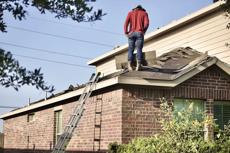 Professional roofer working on a residential roof in North Bend